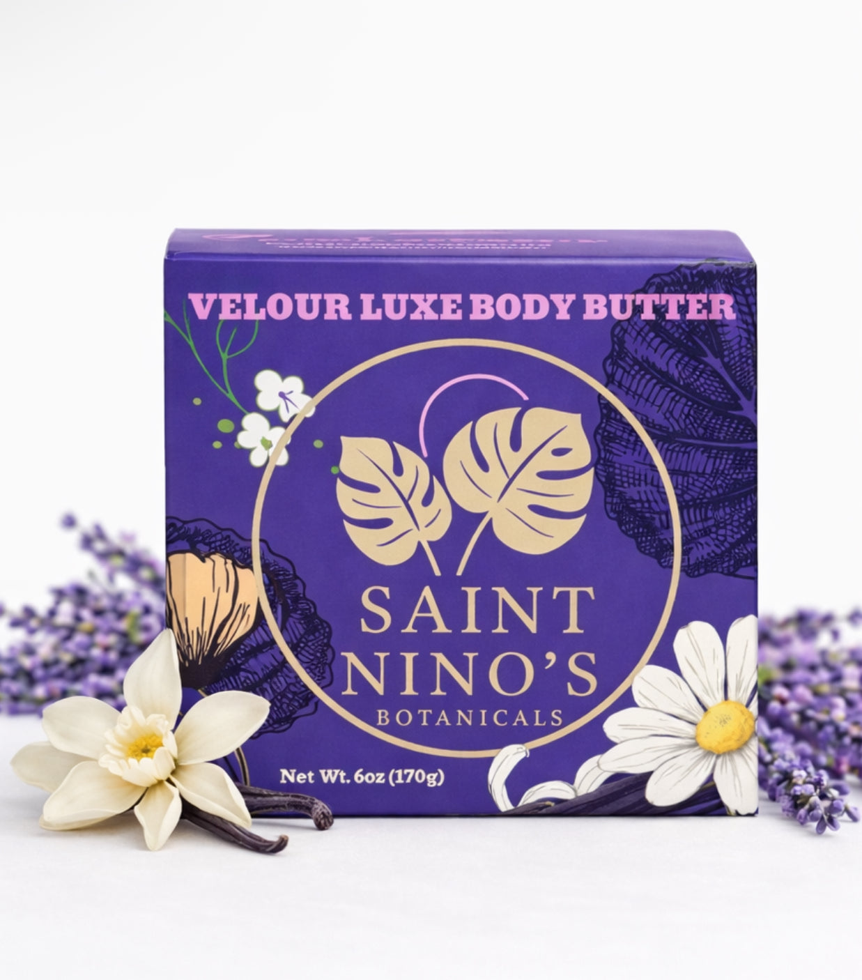 Purple Saint Nino’s Botanicals body butter box with gold circular logo, lavender sprigs, and vanilla flowers displayed in front.