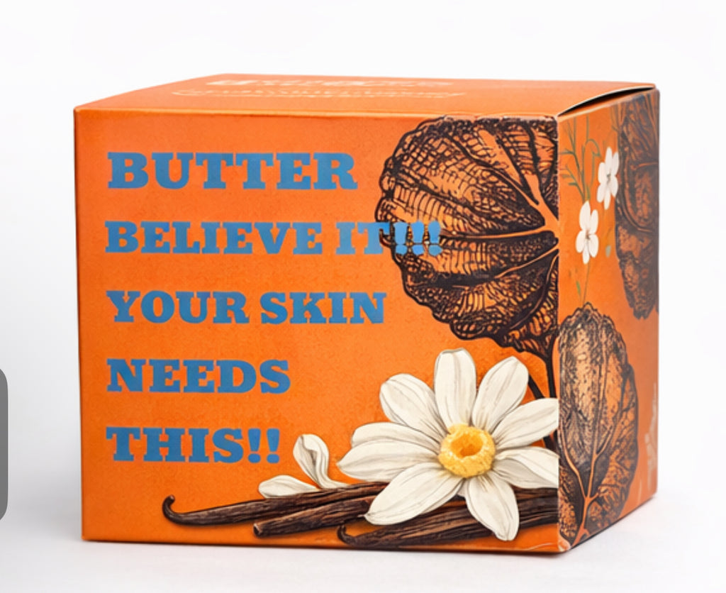 Orange Saint Nino’s Botanicals packaging box with bold text reading “Butter Believe It!!! Your Skin Needs This!!” and floral illustrations.