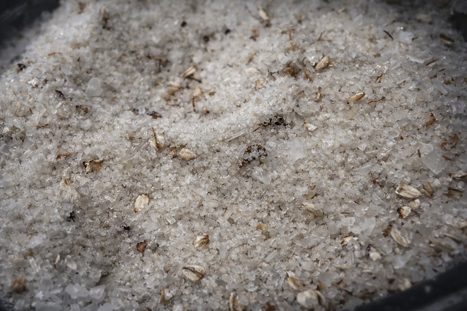 Close-up of salt with small particles and debris